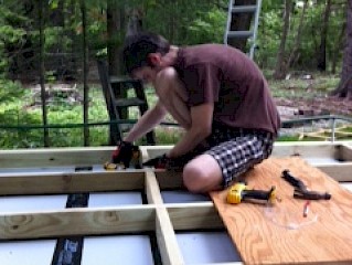 Fastening a blocking piece between two joists, with GRK R4 screws entering diagonally (toe-nailed).
