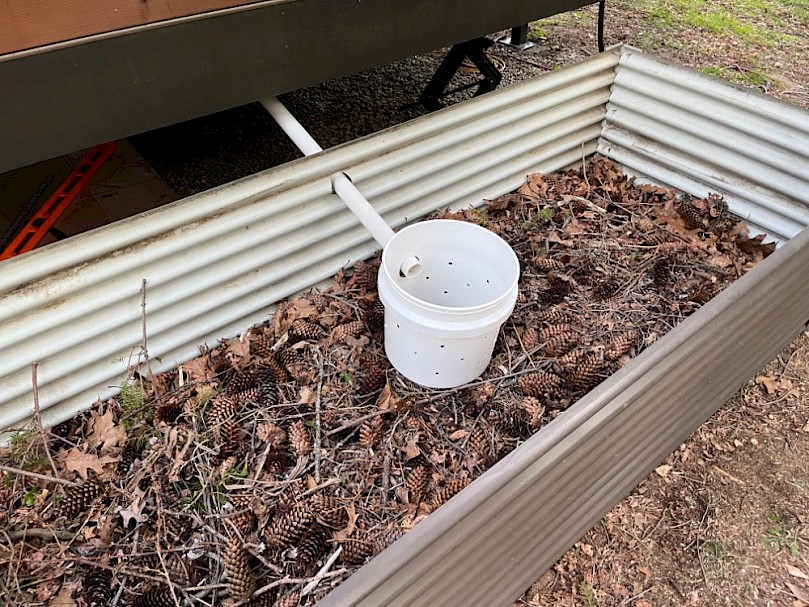 Raised mulch basin under construction with housing in place