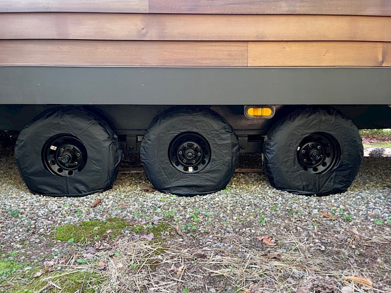 Modified wheel covers with the center cut out on a tiny home